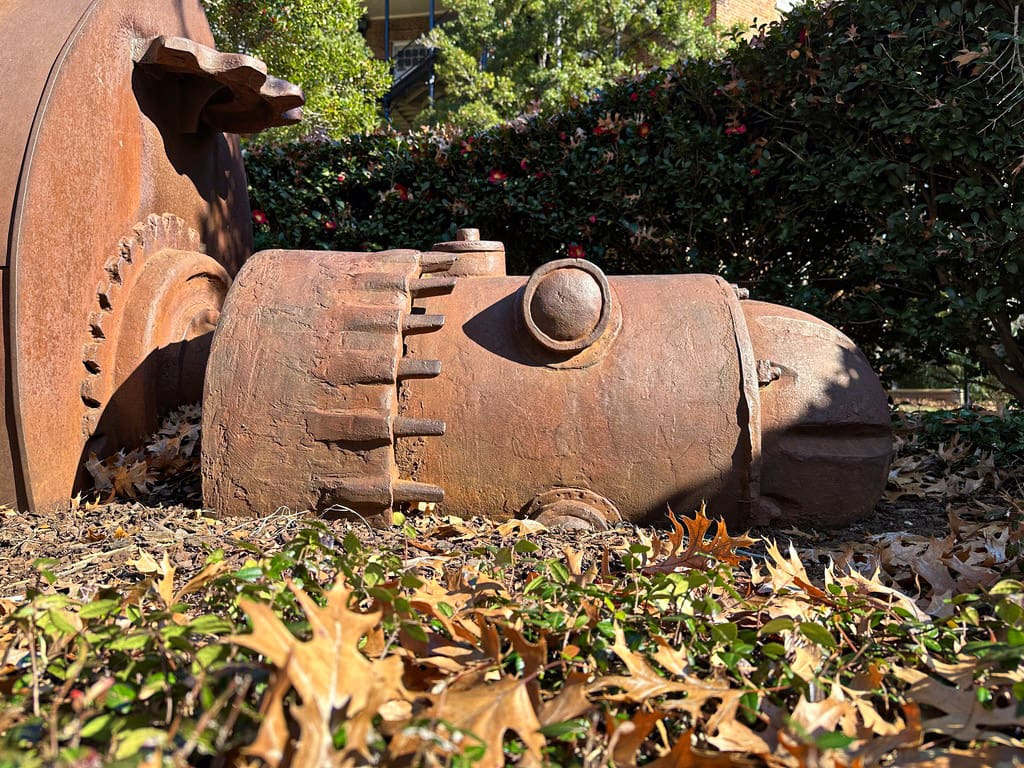 Close-up on the face of a large iron sculpture of a robot.